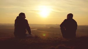 two boys  sitting  and view of sunset- true friends pictures